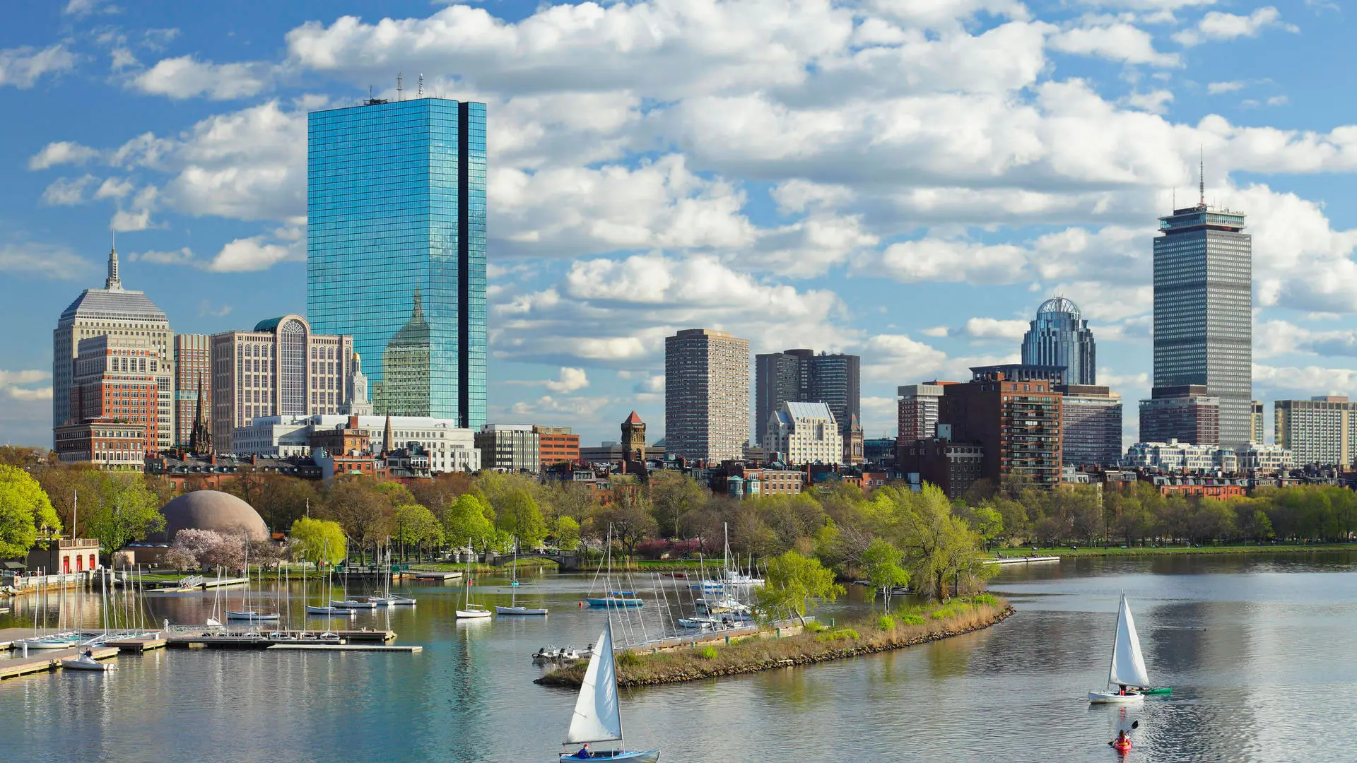 A view of the boston skyline from across the river.