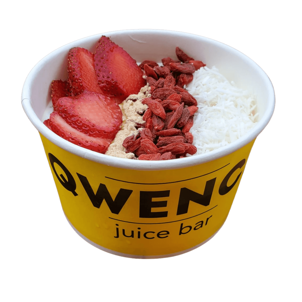 A bowl of strawberries and rice with a yellow lid.